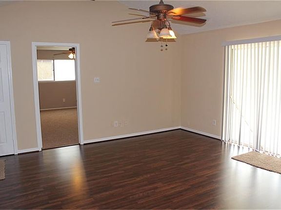 Another view of living area, new blinds at sliding glass doors leading out to the covered back porch