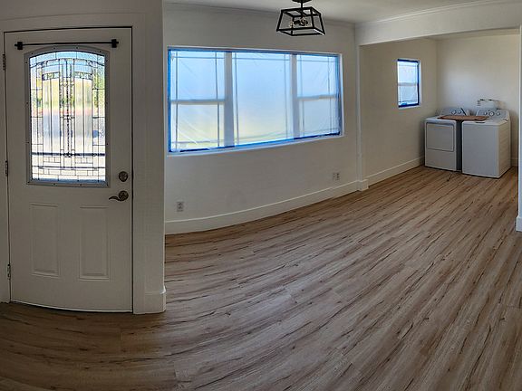 Front door. New outer security door. Dining room area under new LED chandelier.