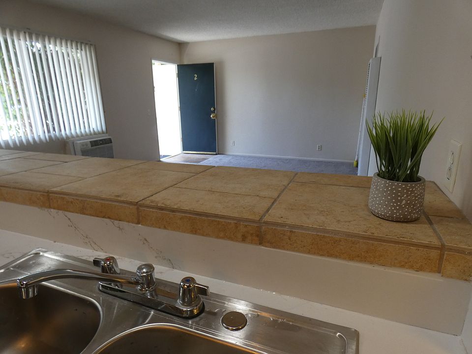 View of living room from kitchen (note new stainless sink). Bar counter with your bar stools on the living side.