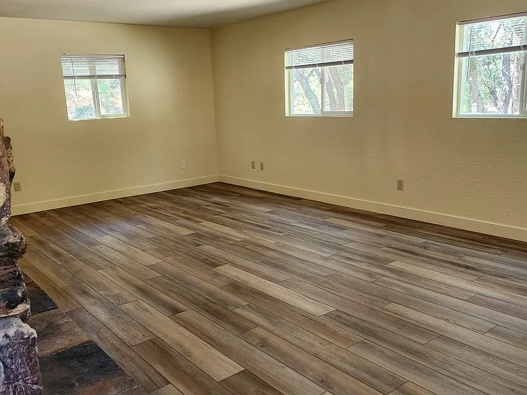 Living room with new flooring and blinds