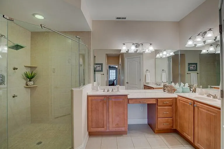 Master bath with Scandinavian Shower, 4 massaging body sprays and dual raised vanities.