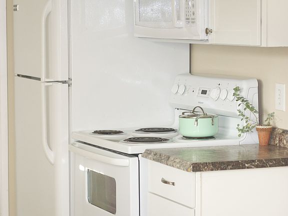 Full-size fridge/freezer, microwave, (4) electric burners and full-size oven.