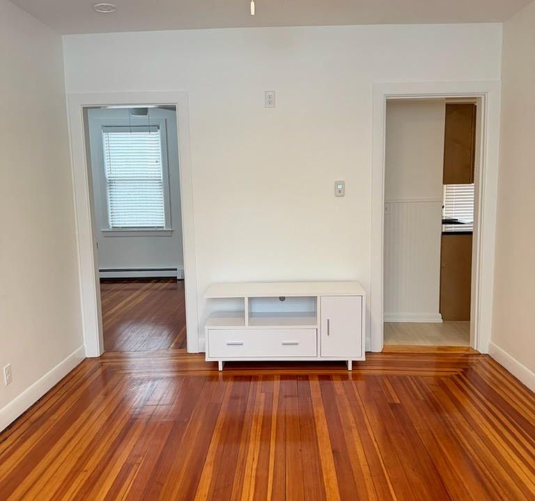 Living Room with entrances to Bedroom & Kitchen. Hardwood floors recently refinished.