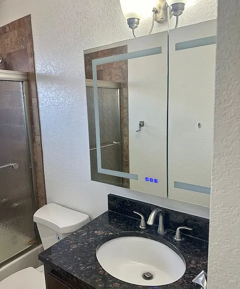 Bathroom with updated features. Large vanity mirror.