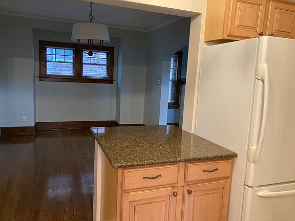 Kitchen looks into a large dining room.