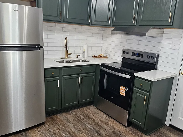 Newly renovated kitchen with new backsplash, flooring, appliances, fixtures and cabinets