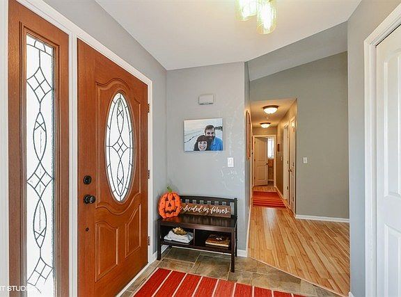Newer front door and entry closet.  White woodwork throughout!