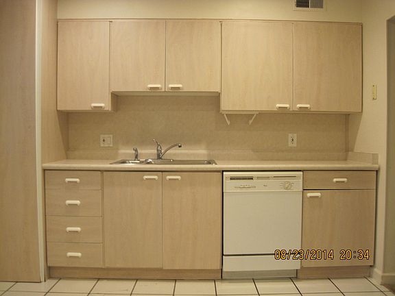 Kitchen North Wall. 40 gal. water heater behind floor to ceiling cabinet door on the left. Dishwasher is newer.