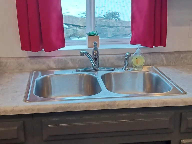 Double stainless steel sink with East window view