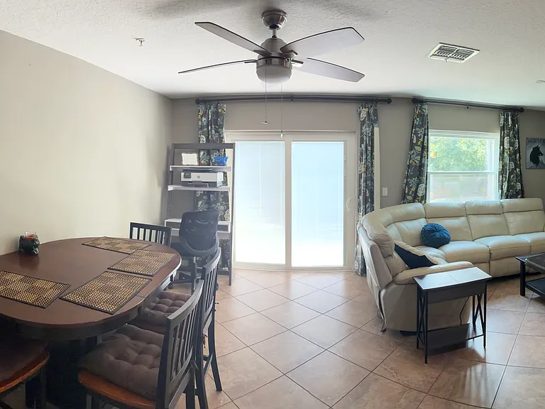Dining room area on left, living room area on right, and back porch entrance through sliding door in back.