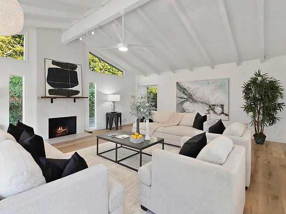 Livingroom with new lighting and ceiling fan.
