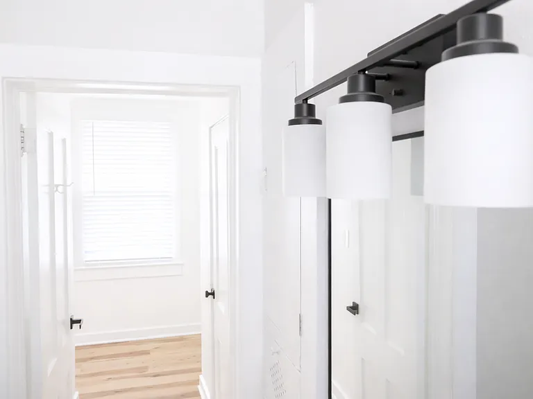 Updated bathroom with modern vanity lighting and clean finishes