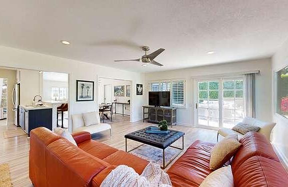 Our living room is light and bright and has sliding glass doors to the outdoor lounge as well as the pool area.