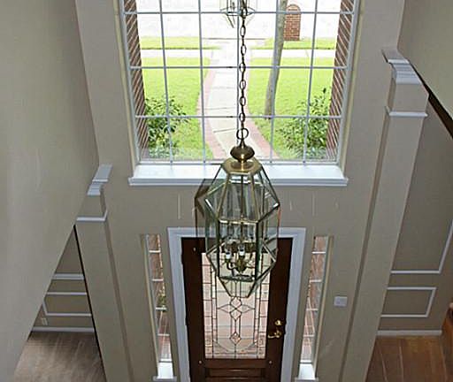The Foyer Features New Tile and a Beveled Glass Mahogany Door.