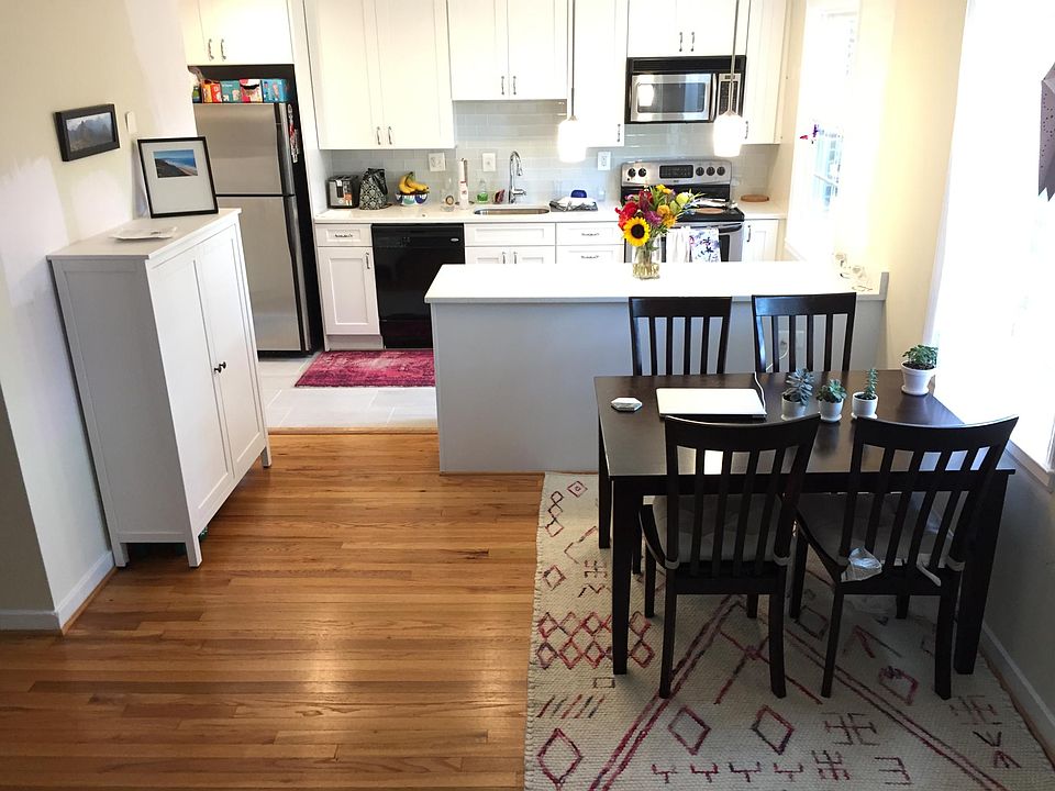 View of dining room and kitchen (fridge is full-sized)