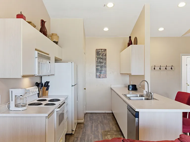 Kitchen with dishwasher, stove top, oven, microwave and washer and dryer