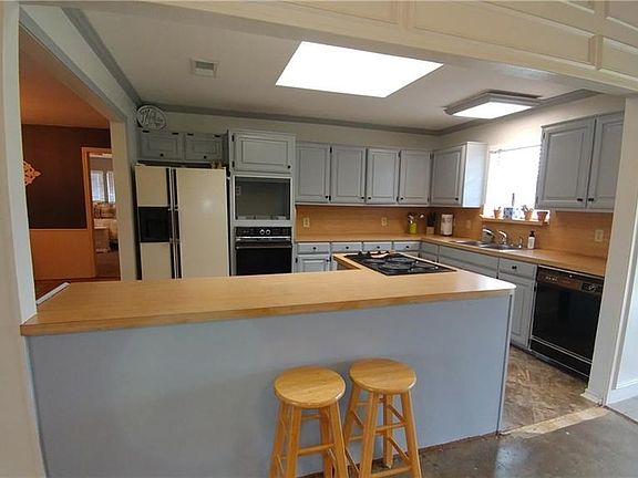 Open kitchen with breakfast bar and skylight...slider to covered back patio