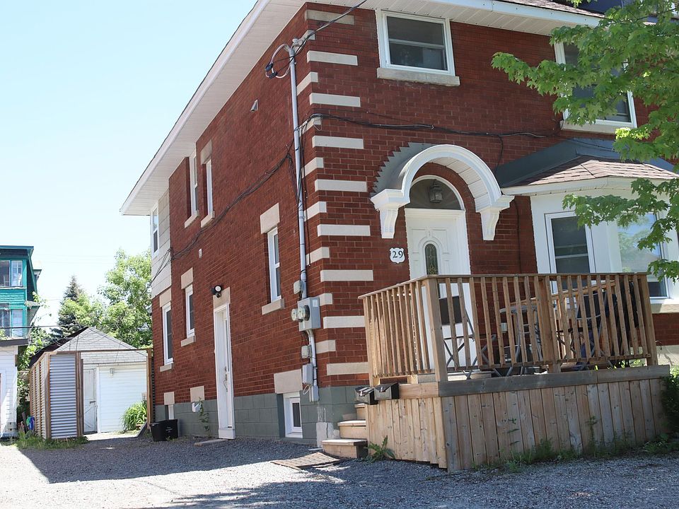 Front view of house with side entrance/parking space.