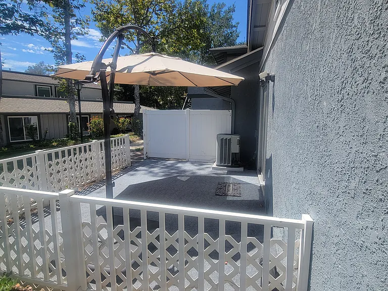 out door patio off kitchen sliding door with new exterior carpet. breeze in afternoon
