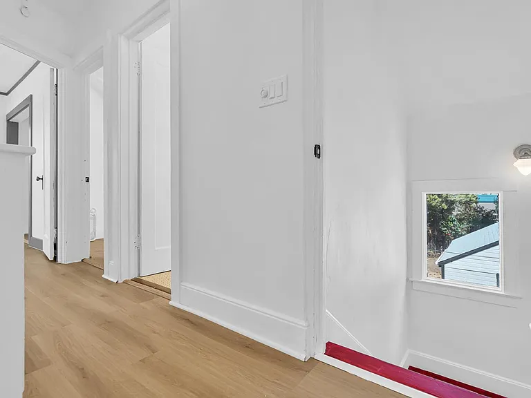 Upstairs hall with a view of entrances to the bedroom, laundry room/bonus space entrance, and bathroom #2.