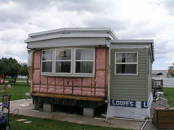 End and tip-out with new windows and siding going up