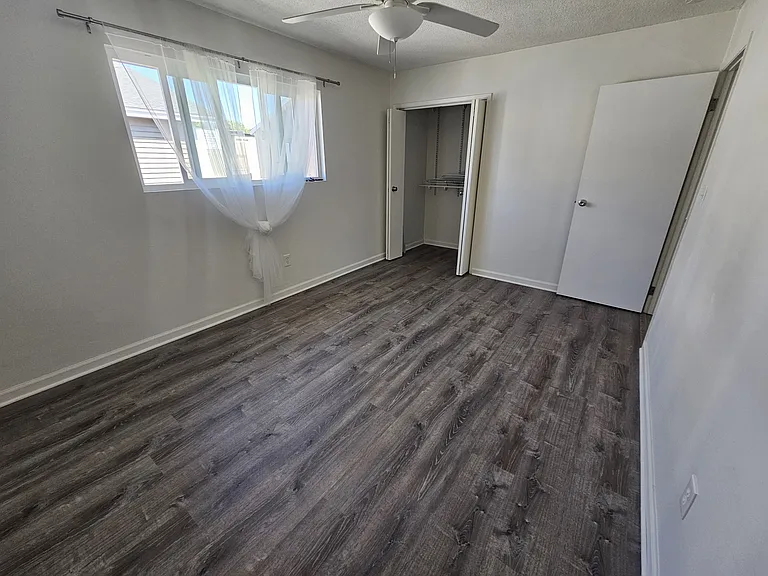 East bedroom with ceiling fan