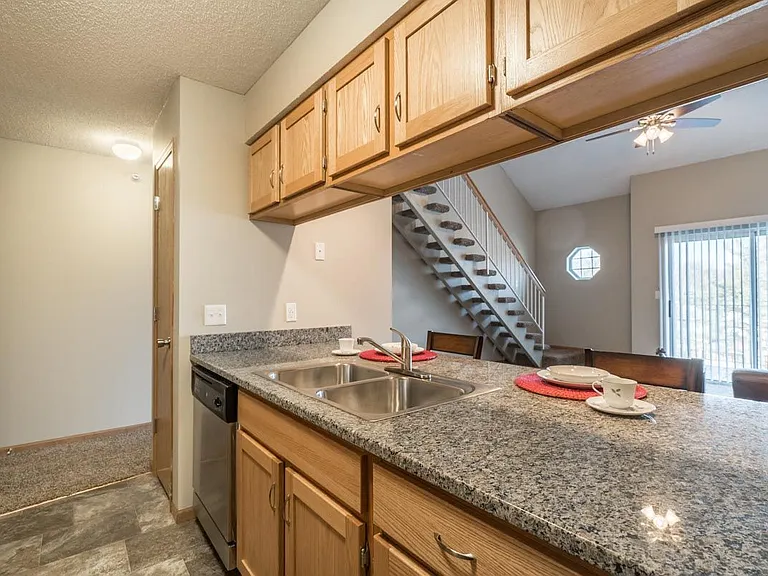 Our galley-style kitchens have a view into the living room, letting in natural light.