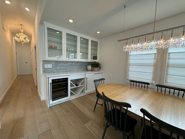 Dining area features an integrated bar, complete with Sub-Zero wine fridge, ice maker and beverage drawers