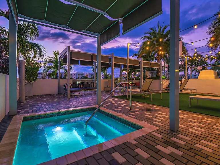 Tranquil Spa Tub Under Canopy and String Lights at South of Atlantic