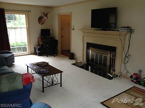 Family room has hardwood floors under carpet, crown moulding, and a wood burning fireplace!