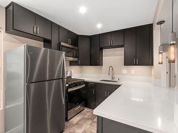 black kitchen with white counters