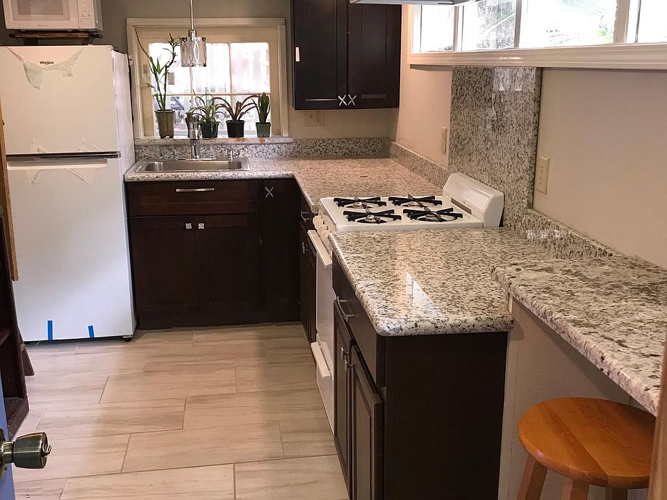 Bright kitchen with fridge, microwave, stove, oven