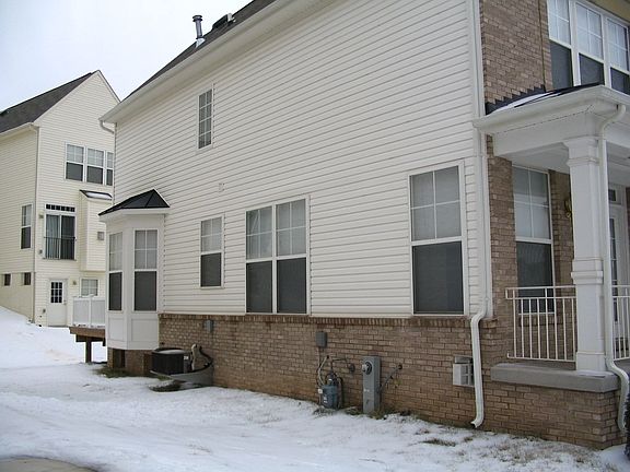 Bay window and brick water table on the side