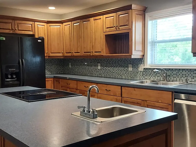 Beautiful custom kitchen. Jenn-air flat top stove with convection oven. Very quiet dishwasher. Garbage disposal.
