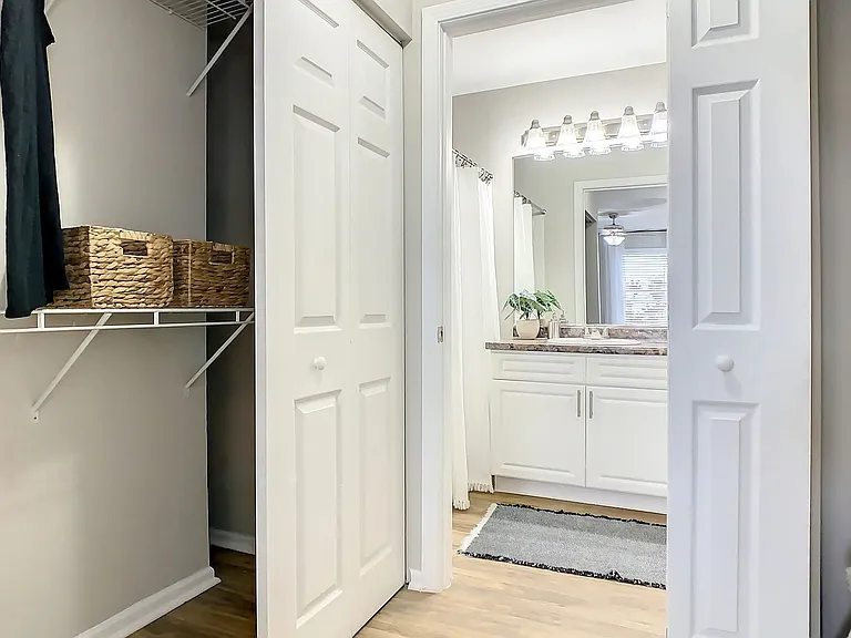 Marvel at the lavish primary bedroom's walk-through closet, offering stylish yet practical storage solutions in this seamless and elegant space.