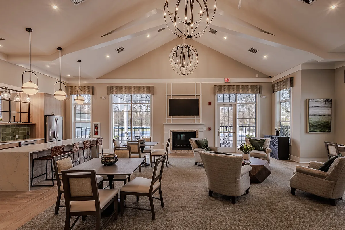 Welcome to Atlantic Manor Apartments, where elegance meets comfort. Our beautifully designed lounge area features high ceilings, modern lighting, and cozy seating, perfect for relaxation or social gatherings. Schedule your visit today! - Atlantic Manor Apartments