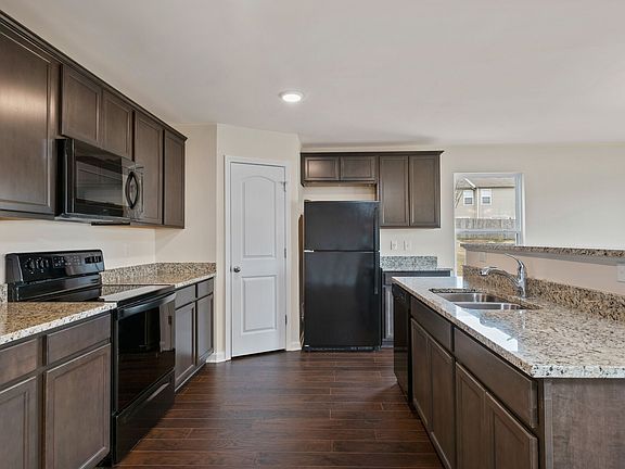 The kitchen features granite countertops, recessed lighting, 36 wood cabinets and more