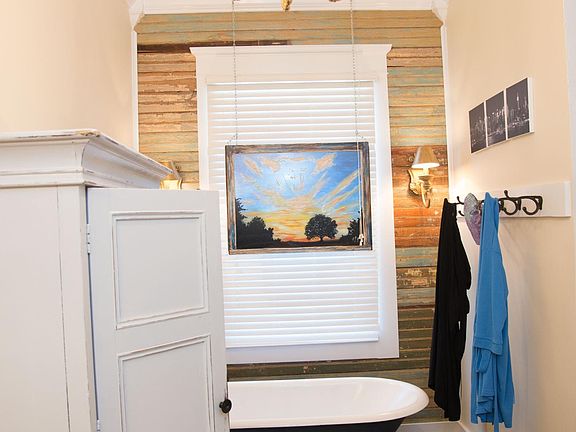 Bathroom one. Has a shower and a claw foot tub.
