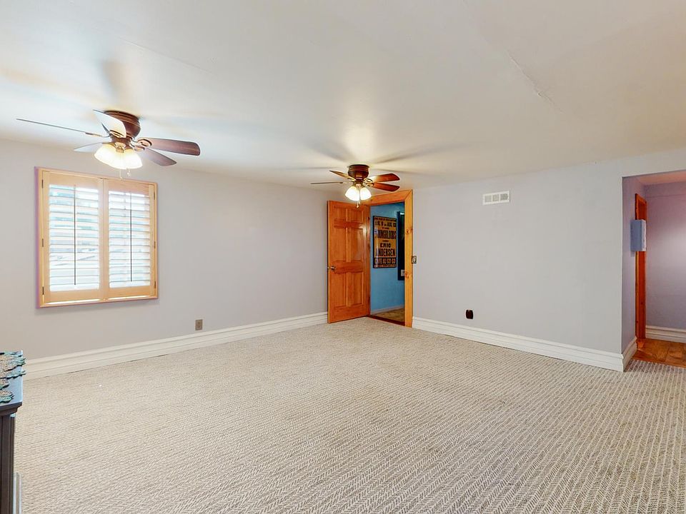 UNFURNISHED MASTER BEDROOM --CUSTOM PLANTATION SHUTTERS AND MAIN ENTRANCE TO APARTMENT WITH SIDE HALLWAY LEADING TO LIVING ROOM