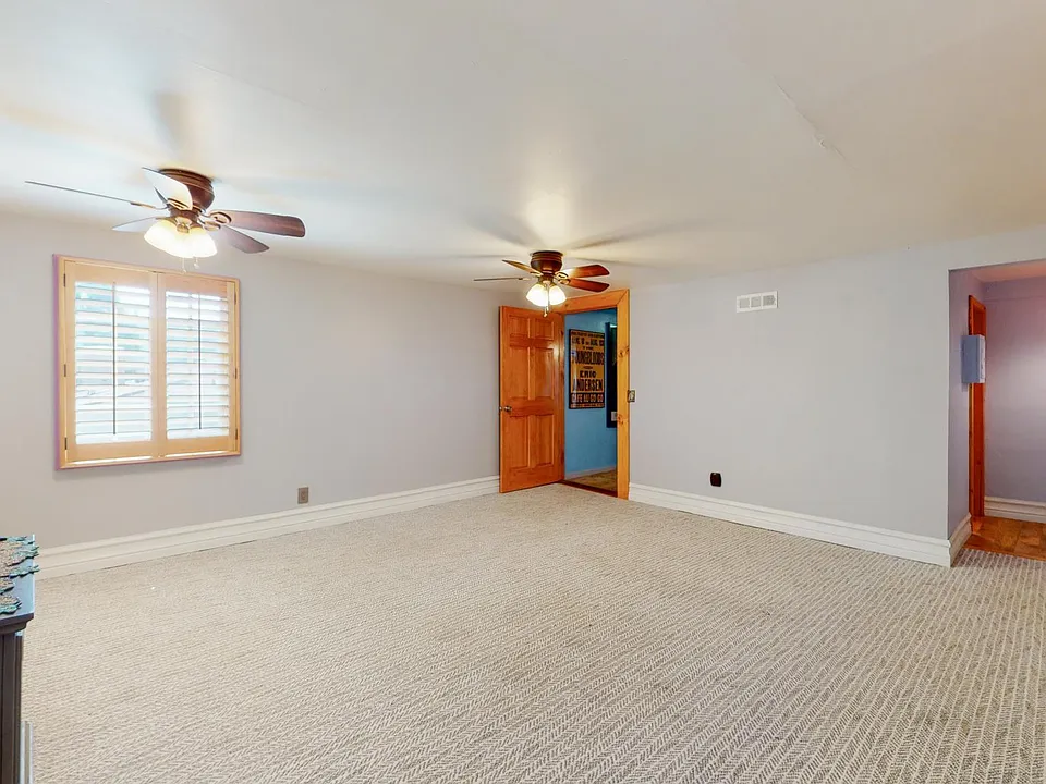 UNFURNISHED MASTER BEDROOM --CUSTOM PLANTATION SHUTTERS AND MAIN ENTRANCE TO APARTMENT WITH SIDE HALLWAY LEADING TO LIVING ROOM