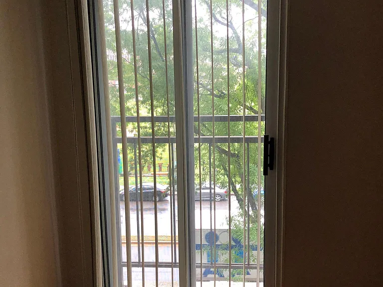 Main room window with shades.