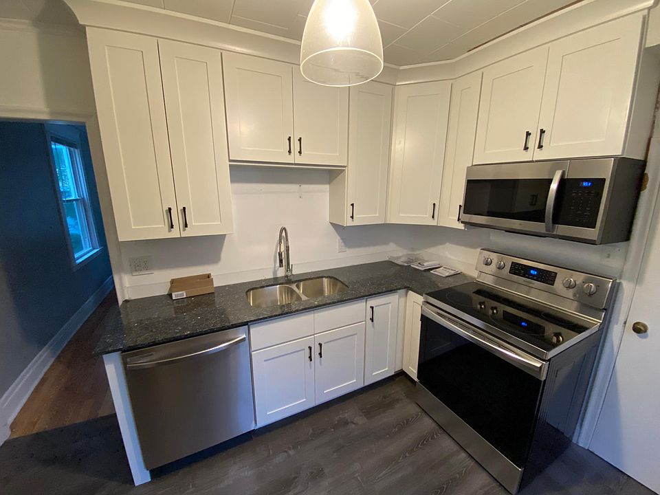 New kitchen with granite countertops and stainless steel appliances.