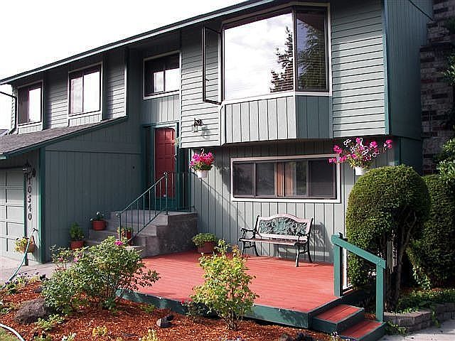 Front of house with deck to enjoy quiet mostly private front yard.