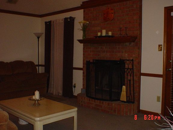Living room with brick fireplace