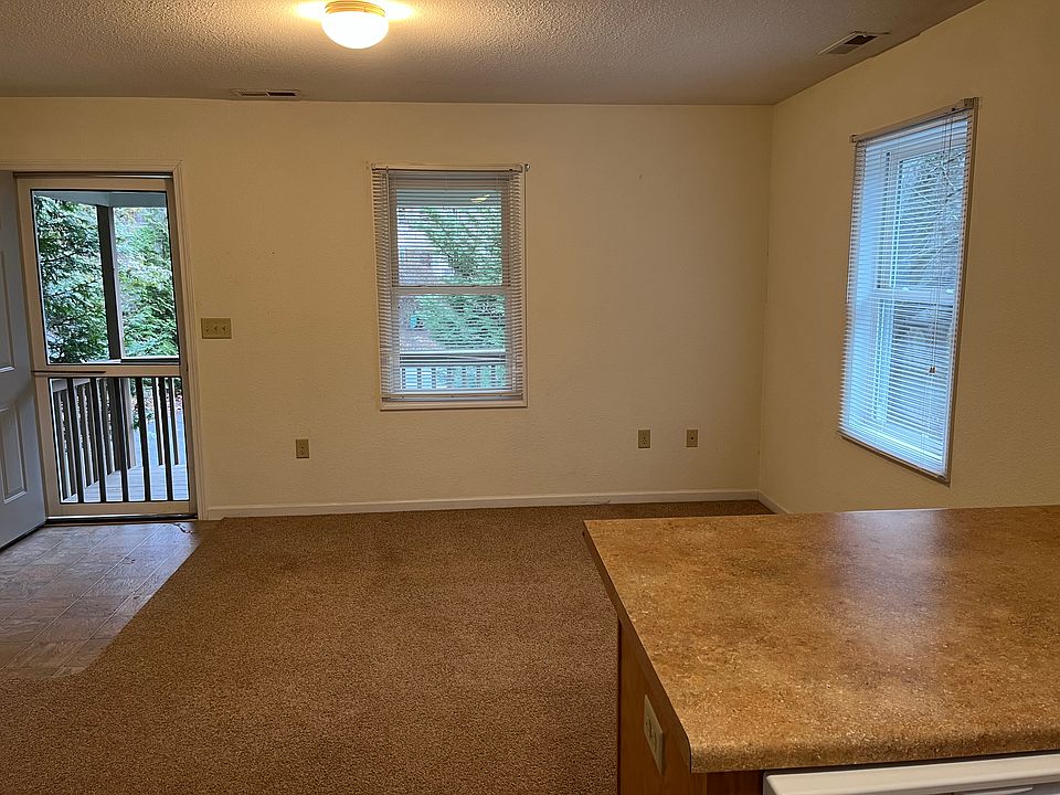 Open living room area with kitchen and closet for washer/dryer connections