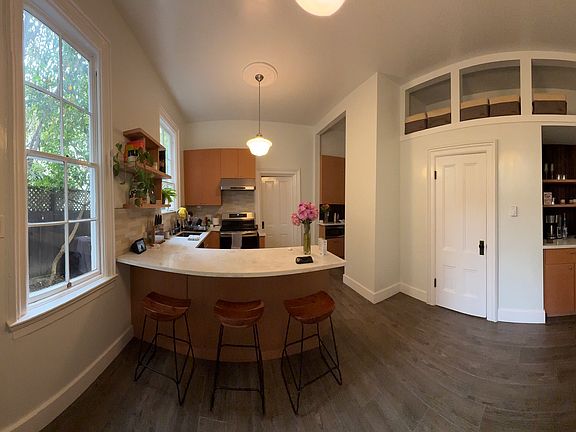 kitchen (unit will be unfurnished). Induction Range. Coffee/wine nook on the right with loft storage above.