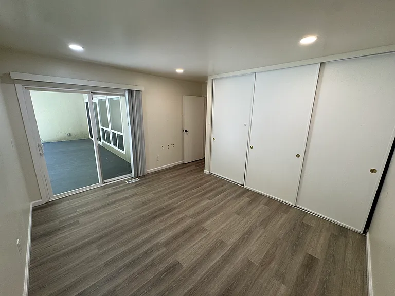 Bedroom 2 with patio access.