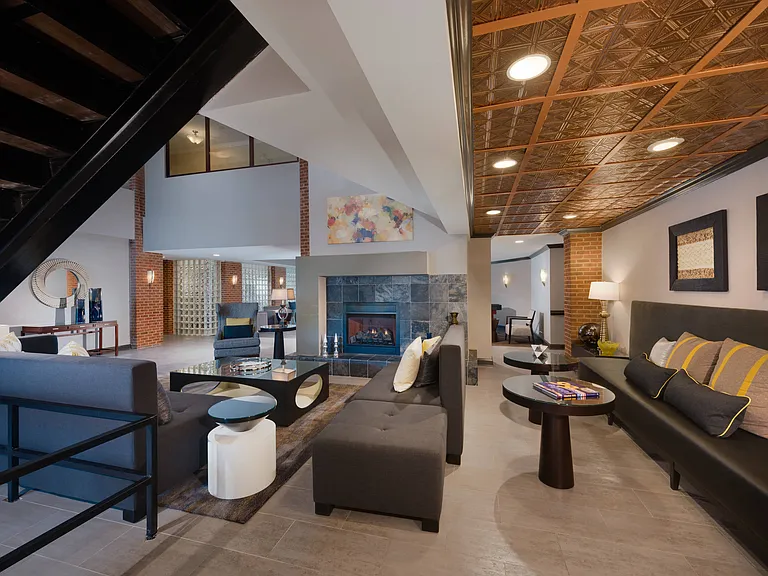 Stylish Resident Lounge with Fireplace, Wet Bar, and Plush Seating Areas