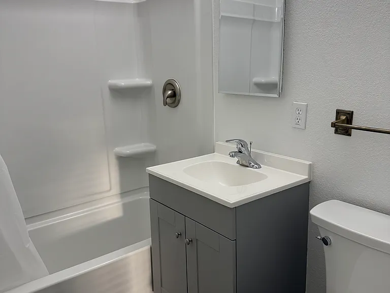 Hallway bathroom with new tub and surround