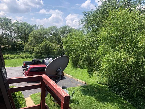 Rear parking lot with wooded view.